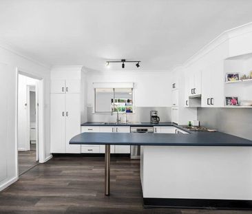 Family home with multiple living zones and large fenced yard - Photo 5