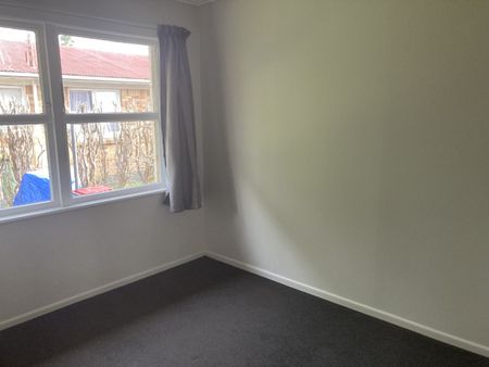 This generous two-bedroom unit offers an open-plan living area, two sizable bedrooms, off-street parking, and a carport. - Photo 5