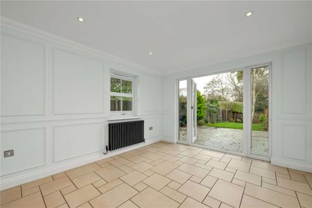 A beautifully presented detached family home in the sought-after village of Lower Bourne, offering spacious and versatile accommodation across three floors. - Photo 3