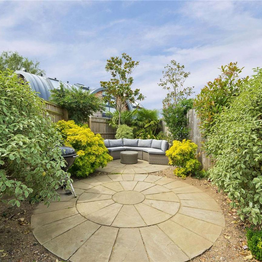 A beautifully presented four-bedroom property with off street parking and a private landscaped garden in a most popular Surrey village. - Photo 1