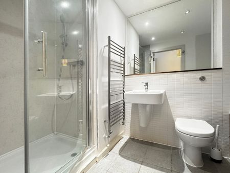 Situated along the High Street overlooking a private communal garden, this modern 2 bedroom flat offers a large balcony, open plan living/dining/kitchen area and allocated parking. - Photo 4