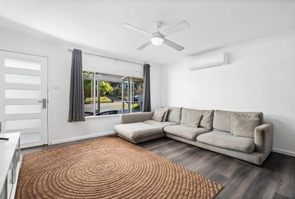 Family home with multiple living zones and large fenced yard - Photo 1