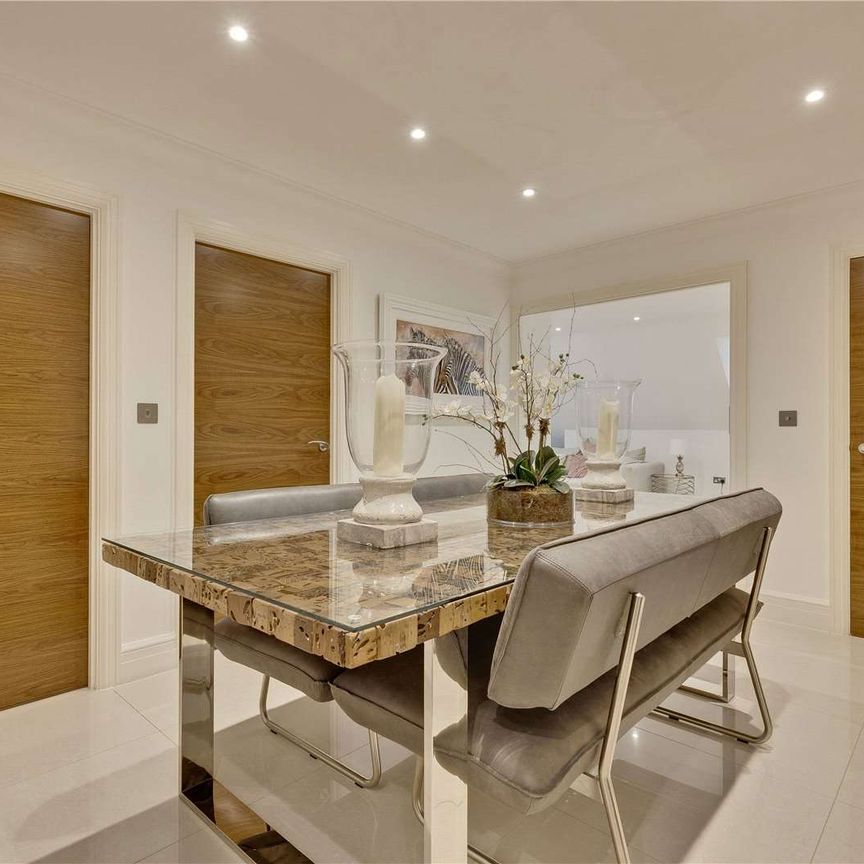 Contemporary apartment conveniently located within half a mile radius of Weybridge station and Queens Road amenities. Includes two underground parking spaces. - Photo 1