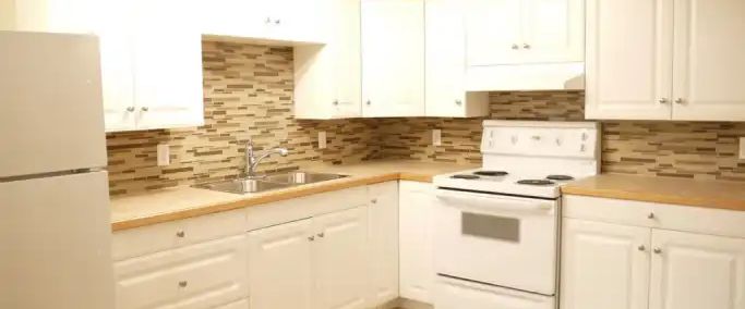 Large1200sf Renod 2BR Bsmt-INCLUDES UTILITIES-newer kitchen/bath+own yard-Pet ok | 6090 Madigan Drive NE, Calgary - Photo 1