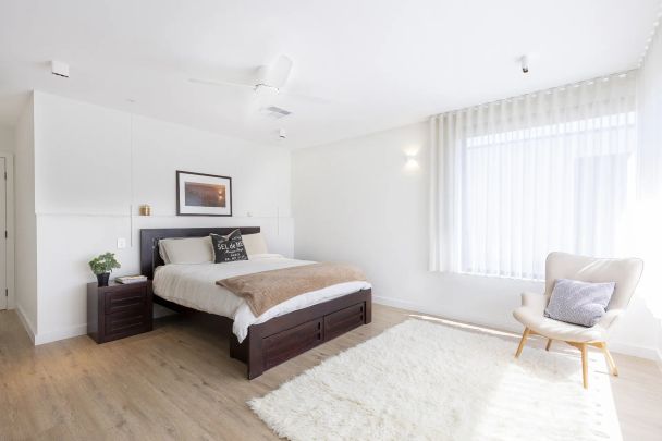 Stylish modern home featuring five bedrooms across two levels - Photo 1