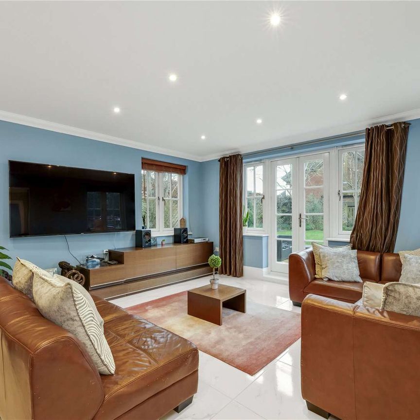 Set within a prestigious private estate, this impressive six bedroom residence offers generous and versatile accommodation perfectly designed for modern family living. - Photo 1