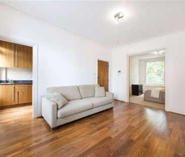 A modern first floor one bedroom apartment with wooden floors in the reception room. - Photo 1