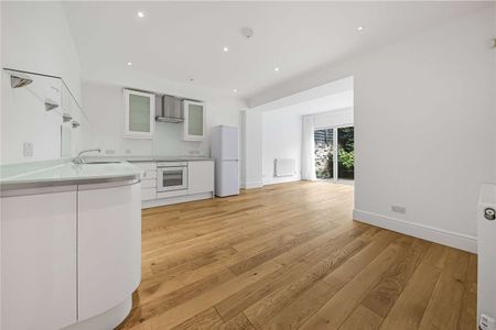 A modern two bedroom garden apartment with its own entrance and private patio garden. - Photo 3