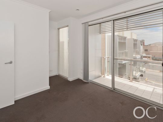 Open the Door to City Serenity with a Private Balcony - Photo 1