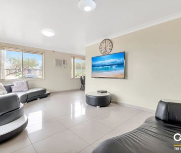 Spacious Three Bedroom Home with a Lock up Garage! - Photo 1