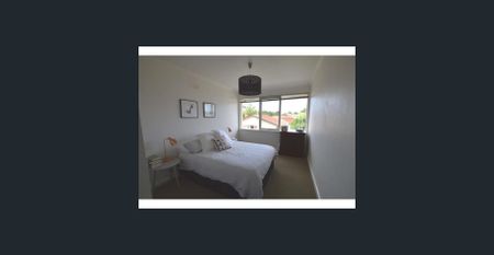 This secure residence offers low-maintenance living with a light-filled interior and practical design - Photo 2