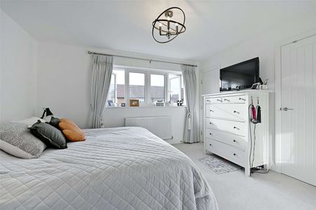 Situated in a peaceful location with open green space to the front, this spacious family home is arranged over three floors and offers well-presented accommodation throughout. - Photo 2