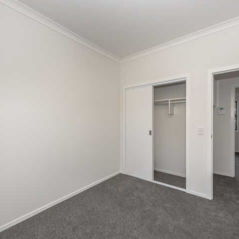 This executive two-bedroom apartment is in a fantastic central location, just a quick 5-minute walk to the CBD, along with nearby restaurants, cafes and a Woolworths supermarket. - Photo 1
