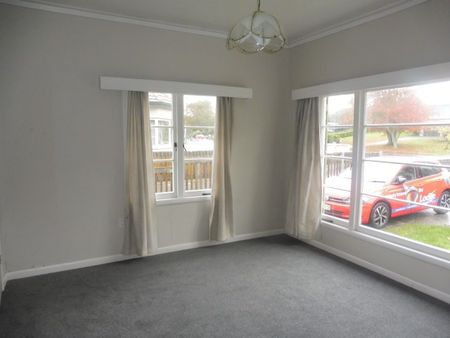 This tidy home at 16 MacDiarmid Road offers three spacious bedrooms, a modern kitchen, open-plan living, and a heat pump for year-round comfort. - Photo 4