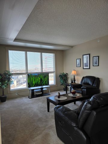 Experience urban elegance in this modern, FULLY FURNISHED, ALL-INCLUSIVE, executive 2-bedroom, 2-bathroom condo. - Photo 2