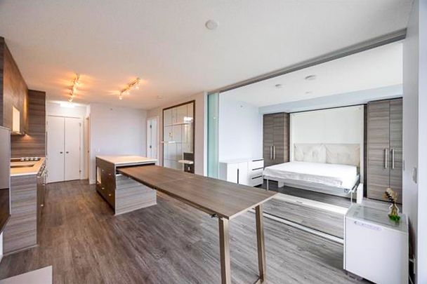 2 Bed Condo | Surrey University District | Parking • Den - Photo 1