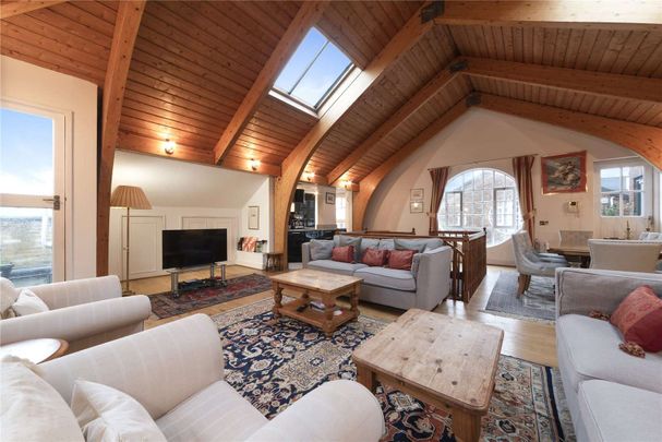 A charming two bedroom penthouse arranged over the second and third floors of this Victorian warehouse conversion located in the heart of Wapping. - Photo 1