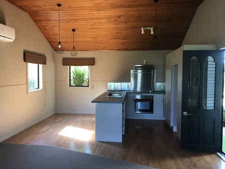 This is a neat and tidy, two bedroom unit at the front of the property, it has open plan kitchen, dining and living with double doors that open out to the deck, a bedroom off either side of the lounge, and the bathroom with shower, toilet and vanity. - Photo 3