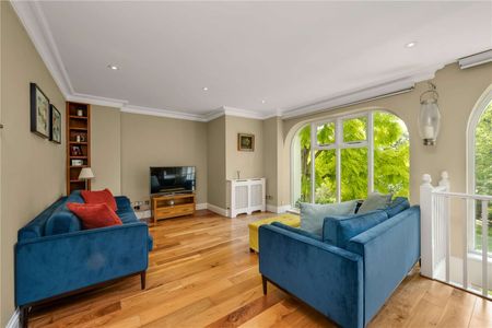 A spectacular three-bedroom home set within a private gated development, combining elegant period features with a dramatic double-height living space and south-facing garden. - Photo 2