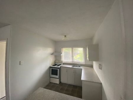 This tidy ground-level two-bedroom unit is perfectly positioned in a highly convenient location. - Photo 3