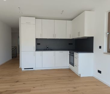 Erstbezug! 4-Zimmer-Gartenwohnung mit Südterrasse, EBK und TG! - Foto 1