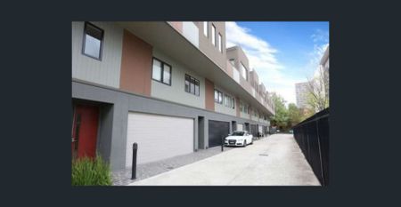 Modern Three-Bedroom Townhouse with Stylish Living in Prime North Melbourne Location - Photo 4