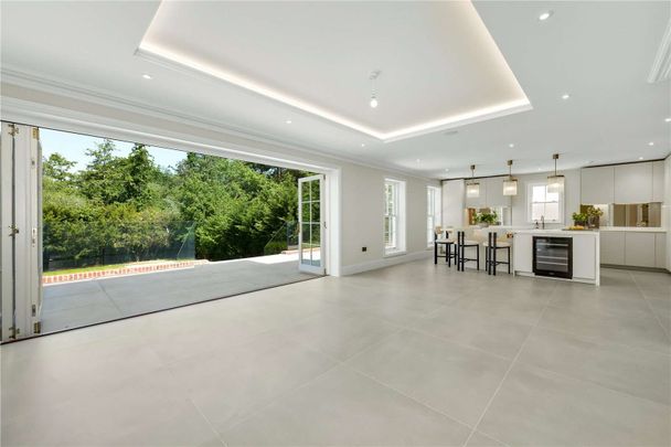Situated within the exclusive Esher Place Estate, this impressive residence offers accommodation arranged over four floors, designed to suit both modern living and elegant entertaining. - Photo 1