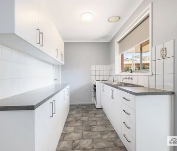 Charming 3-Bedroom Home with Modern Comforts & Outdoor Storage - Photo 4