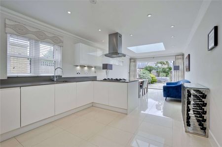 A beautifully presented four-bedroom property with off street parking and a private landscaped garden in a most popular Surrey village. - Photo 4