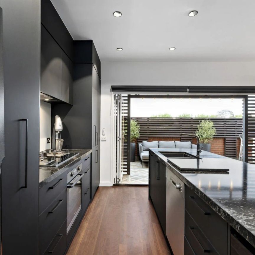 Stylish Three-Bedroom Residence with Secure Garage Parking - Photo 2