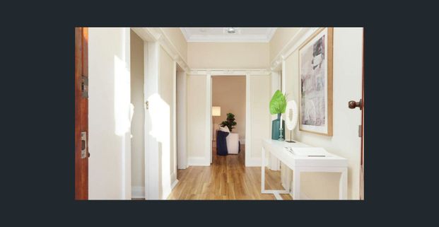 Unfurnished floorboard throughout living room and bedrooms | Laundry room with toilet | Study area - Photo 1