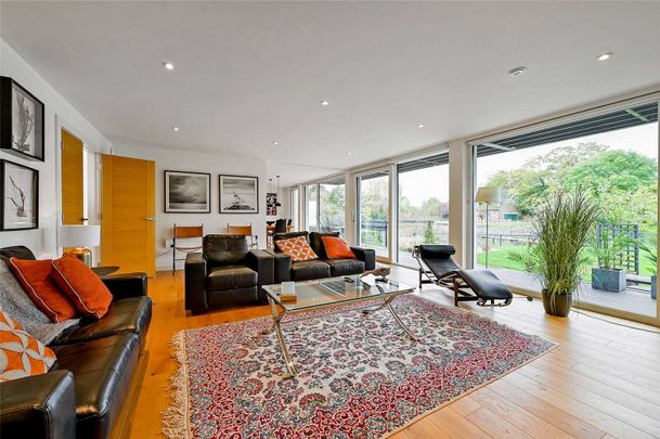 Situated by the water's edge this modern and detached family home boasts exceptional energy efficiency and views of Old Windsor Lock. - Photo 1