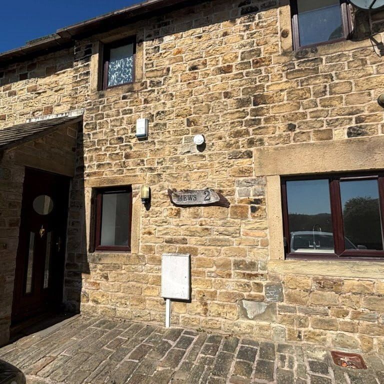 A three bedroom mid-terrace two storey barn conversion with a garage. - Photo 1