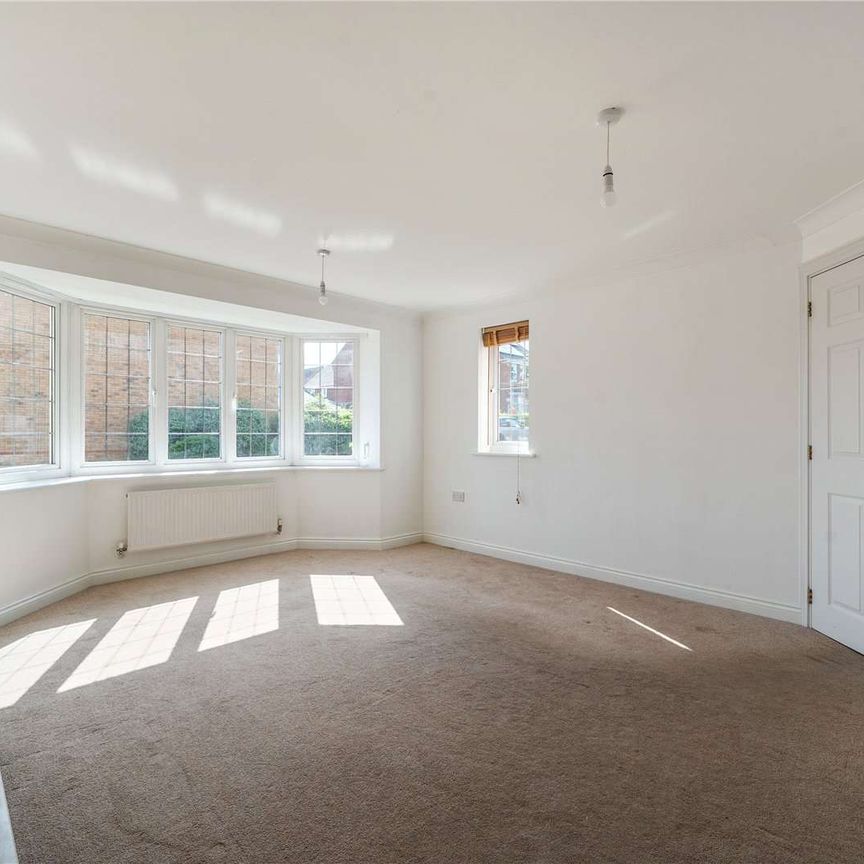 A practical detached four-bedroom home with integral garage. - Photo 1