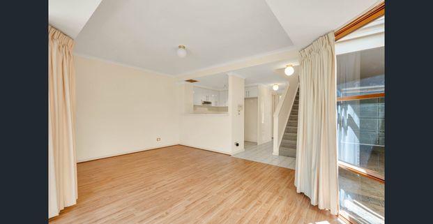 Stylish Two-Level Townhouse with Modern Comforts! - Photo 1