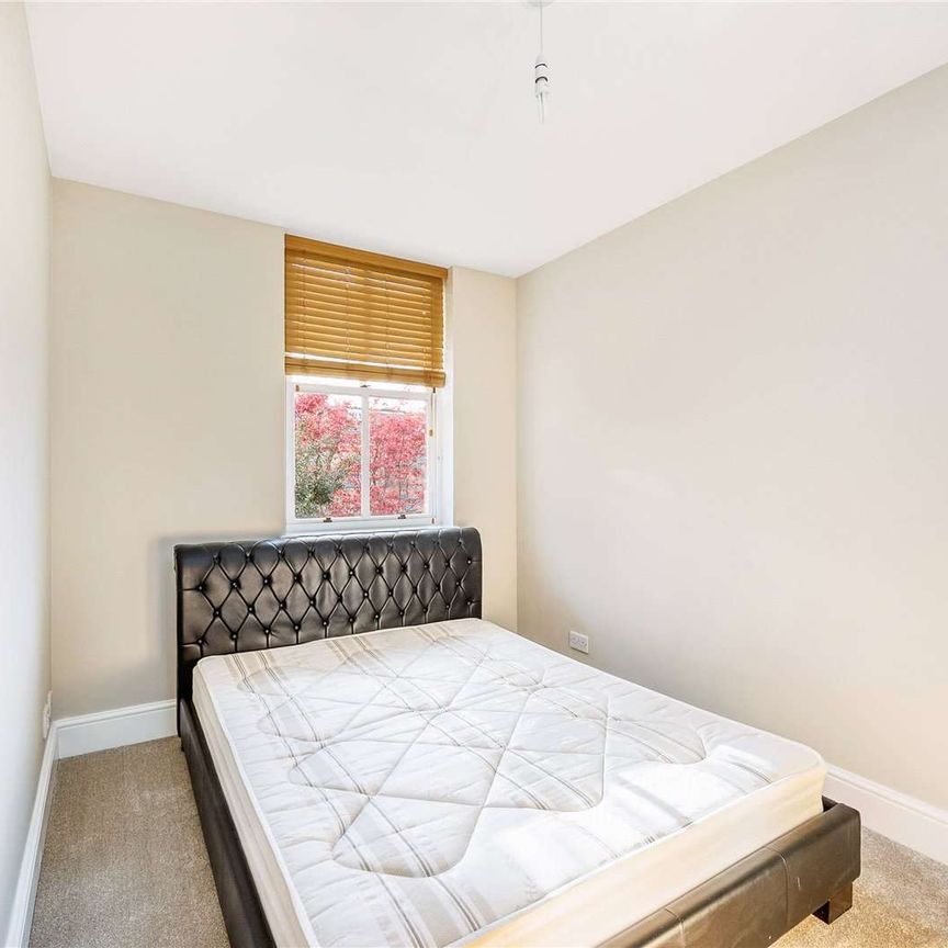 A bright and spacious first floor flat with off street parking for one car. - Photo 1