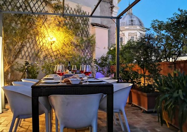 Attic-Monti: 1-6 month rentals. Spacious, furnished 3 Bedroom, 2 bath, living room, dining room, study and large panoramic terrace. Bright, silent, located in well kept Palazzo d’Epoca with elevator and doorman. Near transport and Metro.