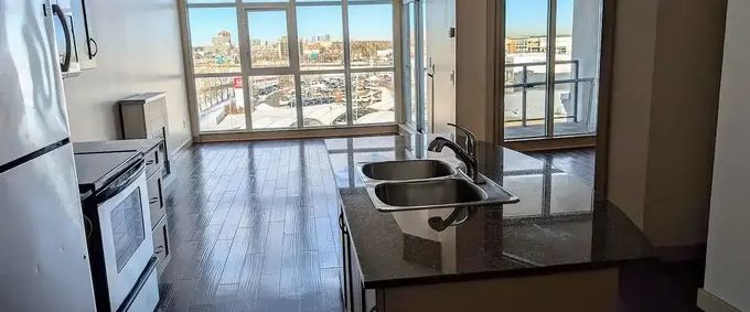 Top Floor 1-bedroom condo, floor to ceiling windows overlooking Downtown | 6307 - 11811 Lake Fraser Drive SE, Calgary - Photo 1