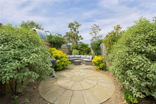 A beautifully presented four-bedroom property with off street parking and a private landscaped garden in a most popular Surrey village. - Photo 1