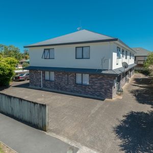 This furnished studio unit includes an ensuite bathroom and a small kitchenette. - Photo 2