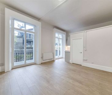 A self contained studio is on the ground floor of a white stucco fr... - Photo 1