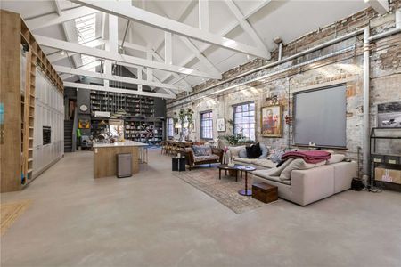 A unique 3,500 sq ft penthouse in a Grade II listed Victorian factory conversion, combining modern open-plan living with original industrial character. - Photo 2