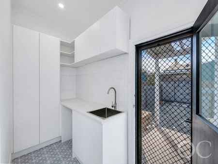 Open the Door to Coastal Charm with Modern Comfort - Photo 4