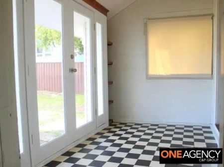“A Charming 2‑Bed Cottage with Polished Floors & Sunlit Sunroom” - Photo 4