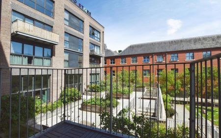 To Let – a one-bedroom flat in the sought after Factory No.1 development, well placed for both local amenities and city links. This immaculate property offers an open-plan reception room with direct access to a balcony, creating a practical space for everyday living and relaxing. The open-plan kitchen is fitted with Smeg appliances, providing a well-equipped setting for cooking and dining. The double bedroom includes built-in wardrobes, offering convenient storage. The bathroom features a rain shower and heated towel rail. The flat further benefits from a 24/7 concierge, EPC rating B and Council Tax band A. - Photo 2