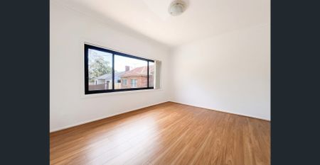 Charming Brick Home with Modern Renovations and Versatile Living Spaces - Photo 2