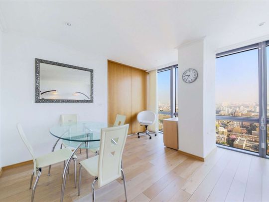 A bright 2 bedroom apartment situated on the 19th floor of this prestigious dockside development located close to the heart of Canary Wharf's business district. - Photo 1