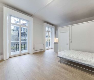 A self contained studio is on the ground floor of a white stucco fr... - Photo 4