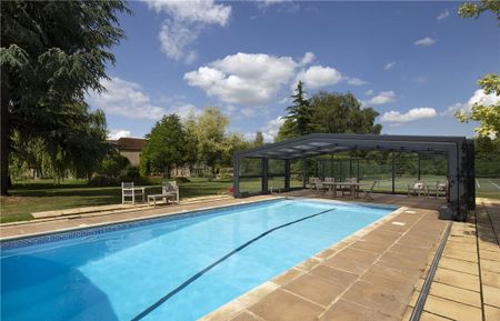 Manor Farmhouse is an impressive Grade II Listed stone built farmhouse dating back partly to the 16th Century with stunning gardens, a covered swimming pool and tennis court situated on the edge of the village. - Photo 5