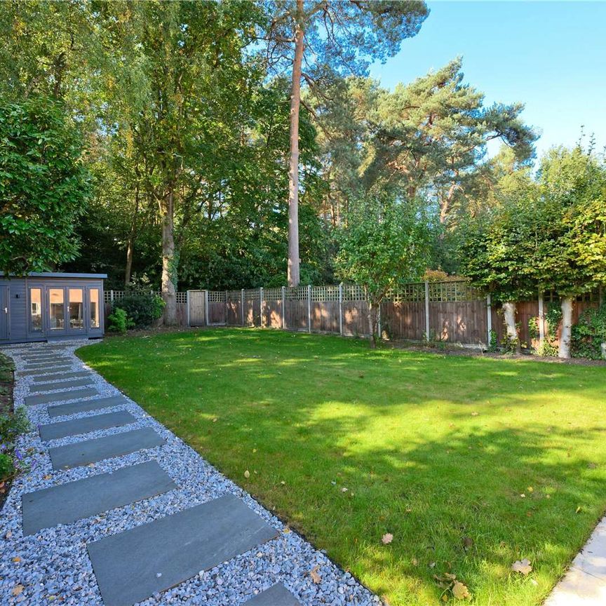 Located in the beautiful village of Pyrford, this lovely home offers flexible accommodation across two floors, complemented by a generous private rear garden backing onto woodland. - Photo 1